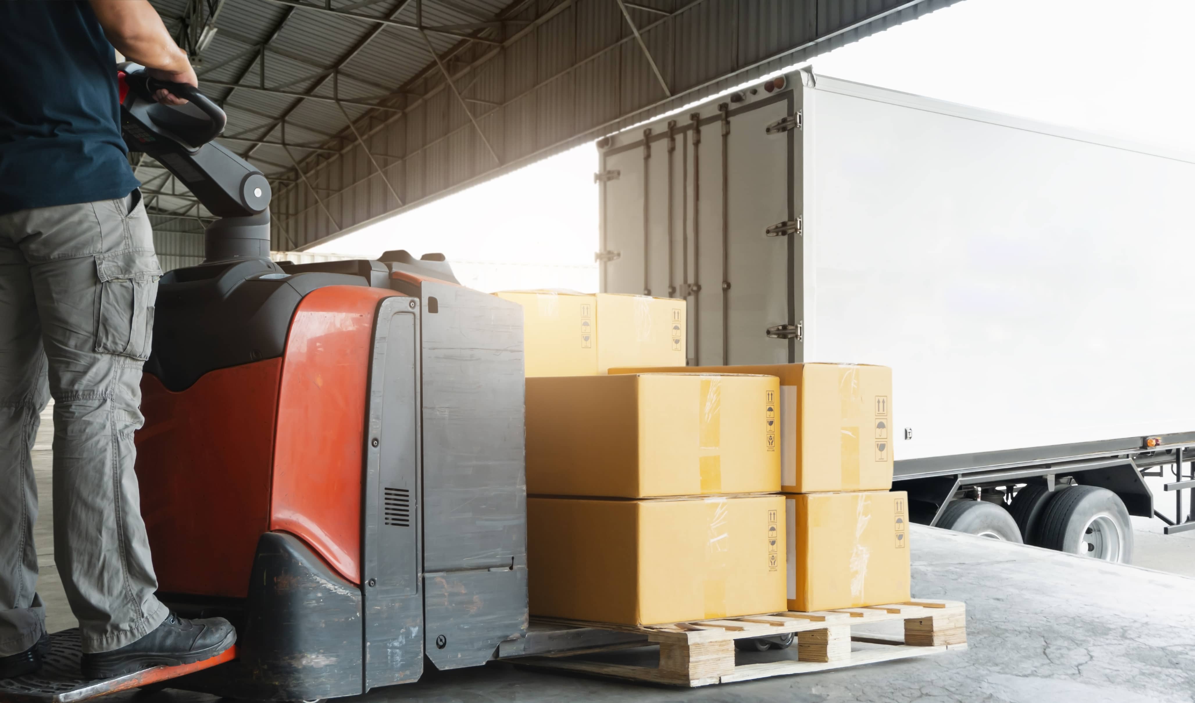 Forklift driver unloading shipment boxes into a truck, Road freight transport, Warehouse industrial delivery shipment goods, Logistics and transportation.